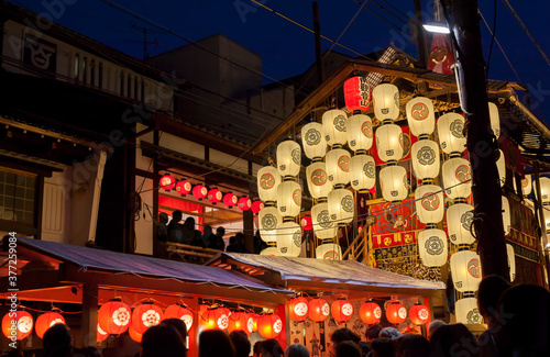 Night view of Yamahoko float with lanterns and people listening to music in Gion Festival in Kyoto, Japan
