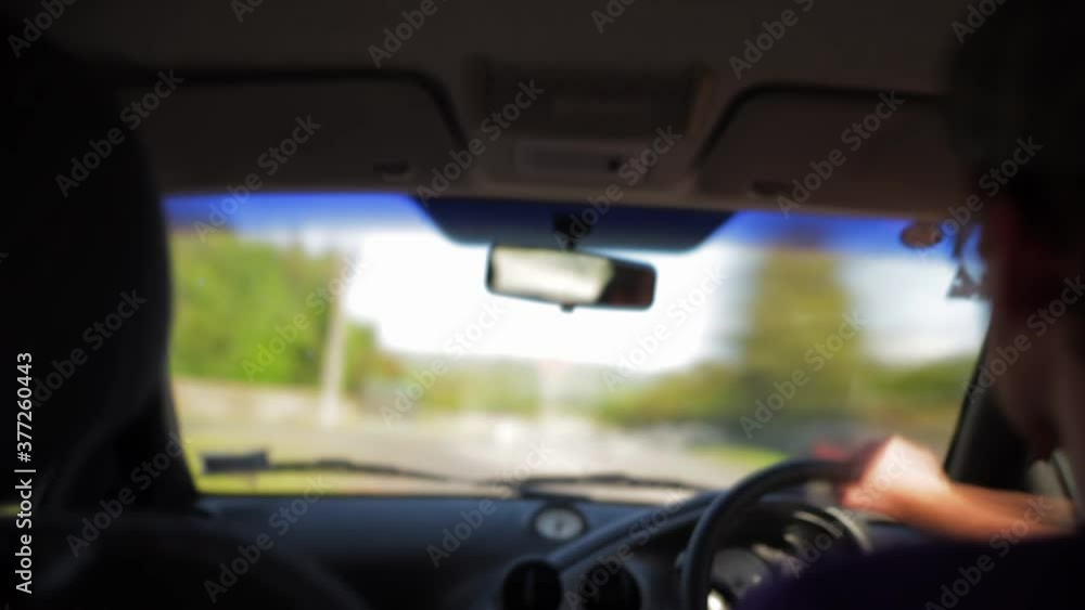 A timelapse looking through the front window of a car over the shoulder of the driver A timelapse looking through the front window of a car over the shoulder of the driver