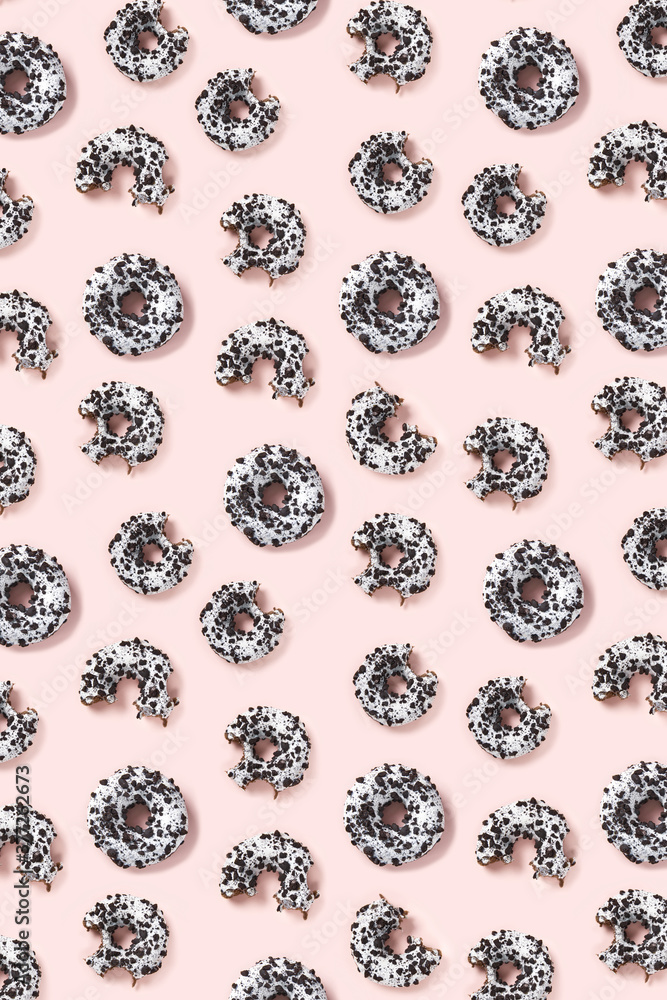 donuts on a pink background top view. Flat lay of delicious nibbled chocolate donuts. used as donut banner or poster background, not pattern. donuts on a pink background top view. Flat lay of delicious nibbled chocolate donuts. used as donut banner or poster background, not pattern.