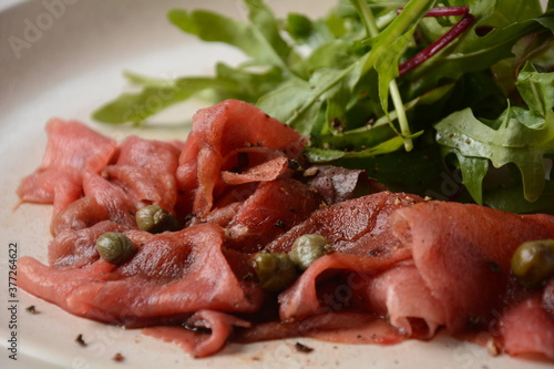 Beef Carpaccio with parmesan, capers and arugula. With olive oil and soy sauce