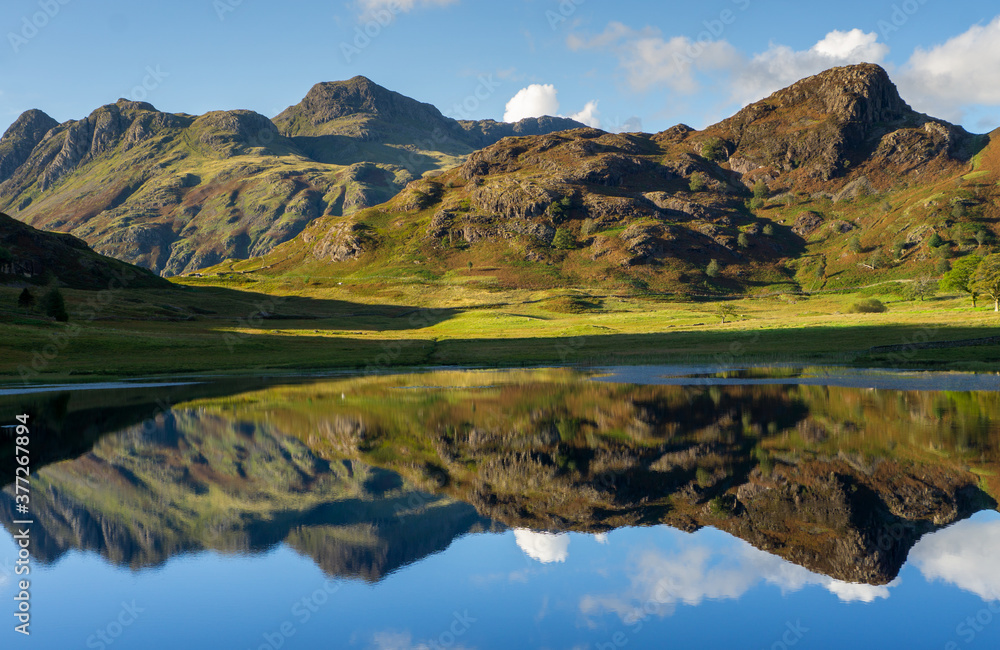 Reflections of the Langdales in Blea Tarn in the English Lake District, UK