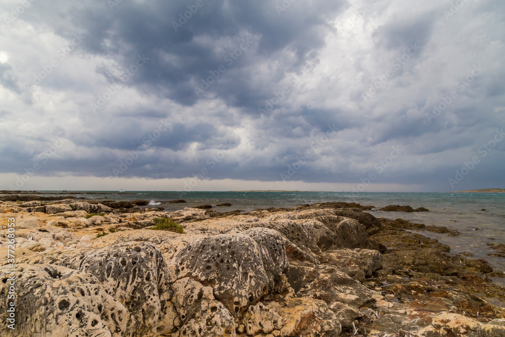 Dramatic storm scenery over the Adriatic Sea, with dark cumulus rain clouds