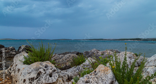 Rock formations on the Adriatic Sea in summer, under warm evening light