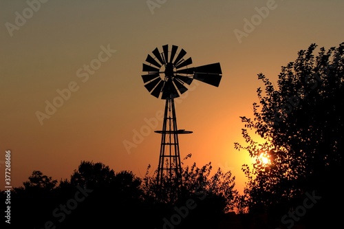 windmill at sunset in Kansas north of Hutchinson Kansas USA.