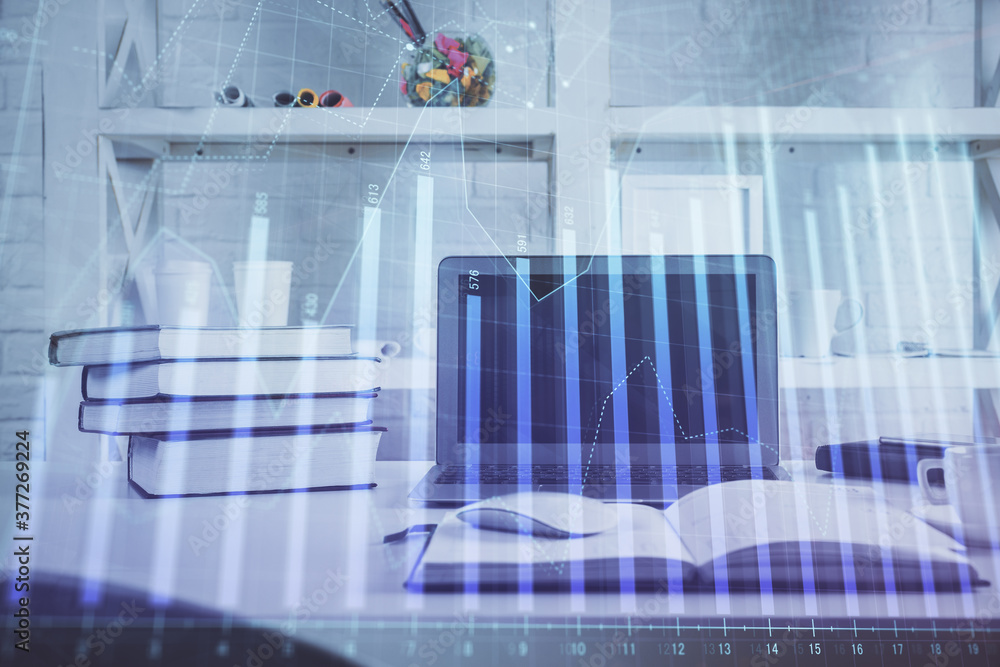 Forex Chart hologram on table with computer background. Double exposure. Concept of financial markets. Forex Chart hologram on table with computer background. Double exposure. Concept of financial markets.