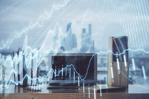 Forex Chart hologram on table with computer background. Double exposure. Concept of financial markets. © peshkova