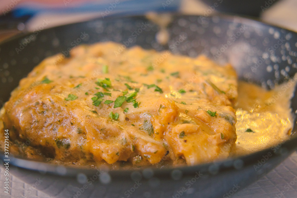 A piece of delicious Italian lasagna in rich fish sauce