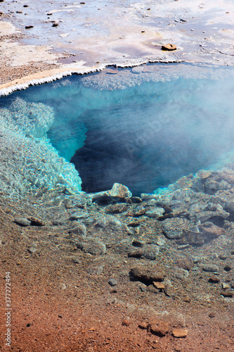 Crystal clear blue water in iceland, geothermal water pool, steam rising up, beautiful nature