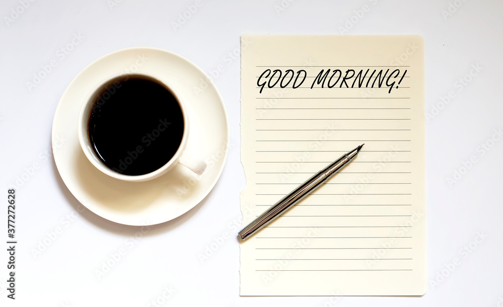 GOOD MORNING - white paper with pen and coffee on white background GOOD MORNING - white paper with pen and coffee on white background