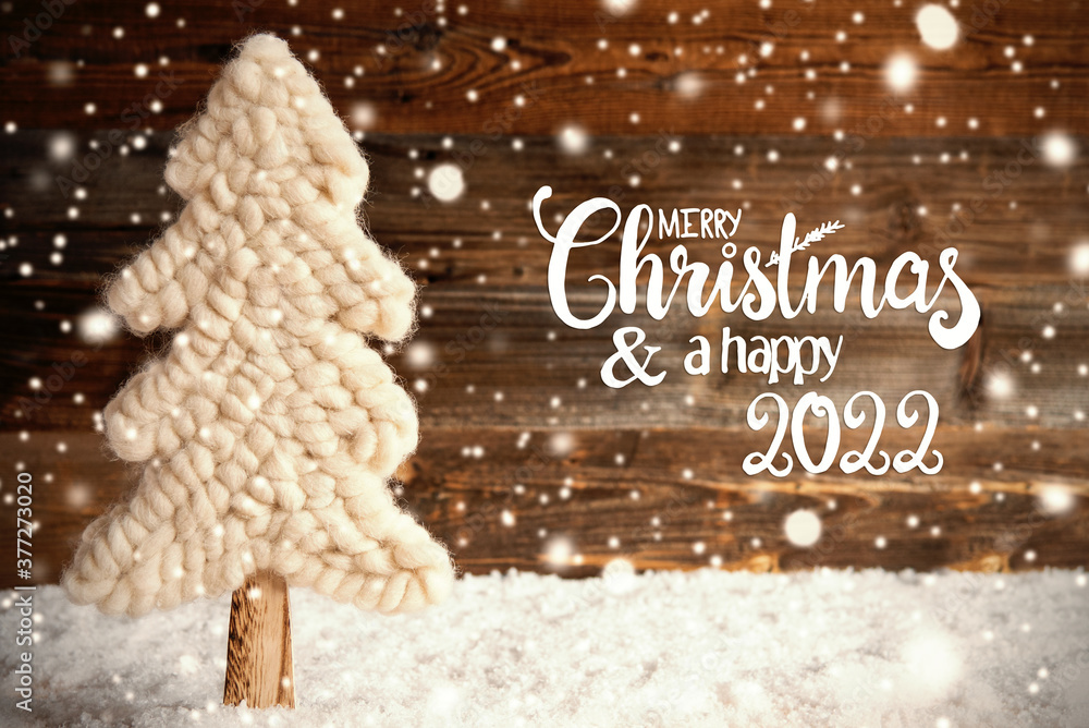 Is It Supposed To Snow On Christmas 2022 English Calligraphy Merry Christmas And A Happy 2022. White Fabric Christmas  Tree With Snow. Brown Rustic Wooden Background With Snowflakes Stock Photo  | Adobe Stock