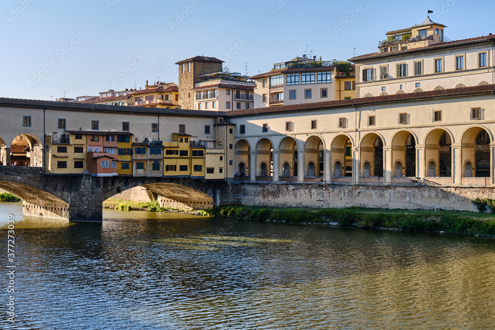 Arch Bridge Over River Against Buildings In City