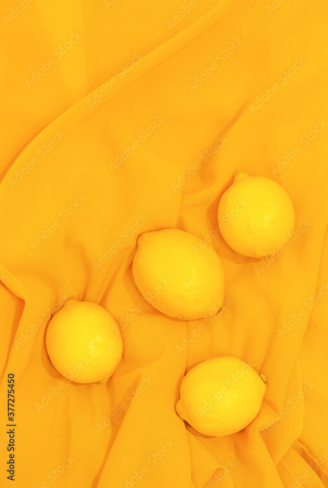 Wallpaper lemons on yellow fabric background. Minimalist fashion yellow  aesthetic Stock Photo | Adobe Stock