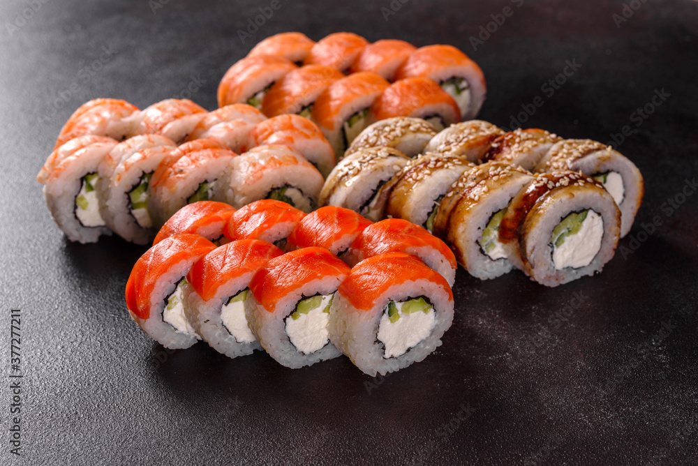 Fresh delicious beautiful sushi rolls on a dark background Fresh delicious beautiful sushi rolls on a dark background
