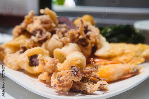 Delicious Slovenian food - breaded seafood (baby octopus, shrimps sardina, mussels and calamary rings in tempura) from fresh catch of the day from Adriatic sea
