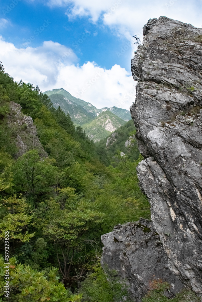 Vertical image of steep rock looking out in the canyon of a mountain range in pozar, north Greece