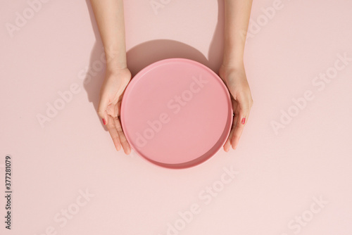 Woman hands and plate top view.