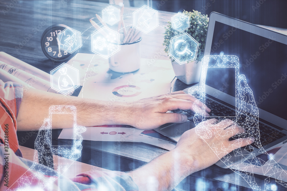 Technology theme hologram with man working on computer on background. High tech concept. Multi exposure. Technology theme hologram with man working on computer on background. High tech concept. Multi exposure.