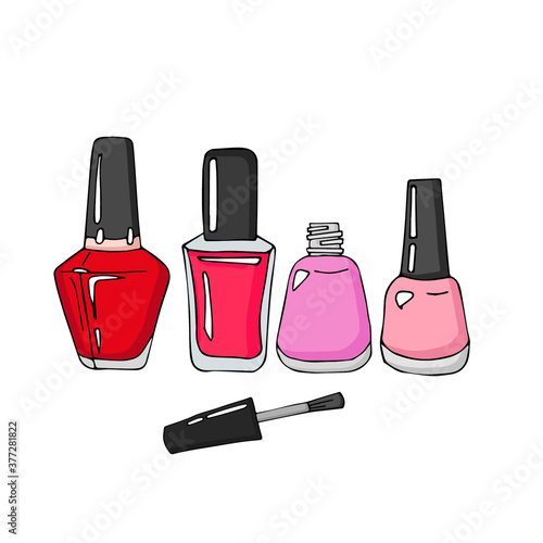manicure and pedicure varnish bottles. One bottle is open and near the cap with a tassel.