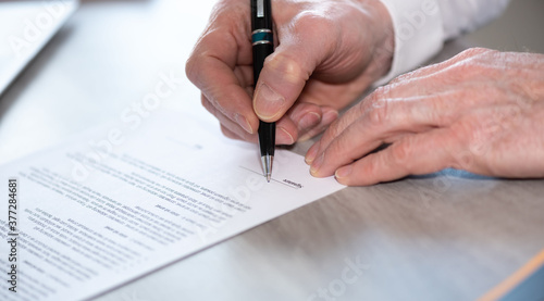 Hand of businessman signing a document
