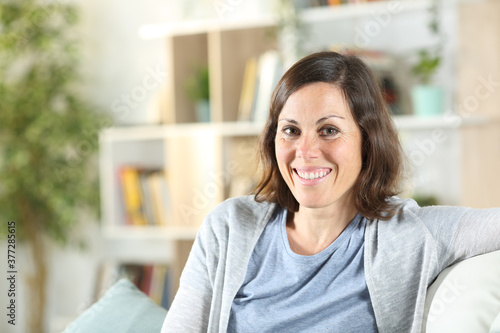 Happy adult woman posing looking camera at home Free Download Happy adult woman posing looking camera at home - GFXLoad