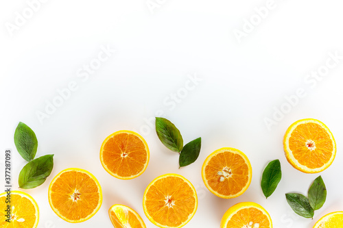 Orange slices on white background top view copy space