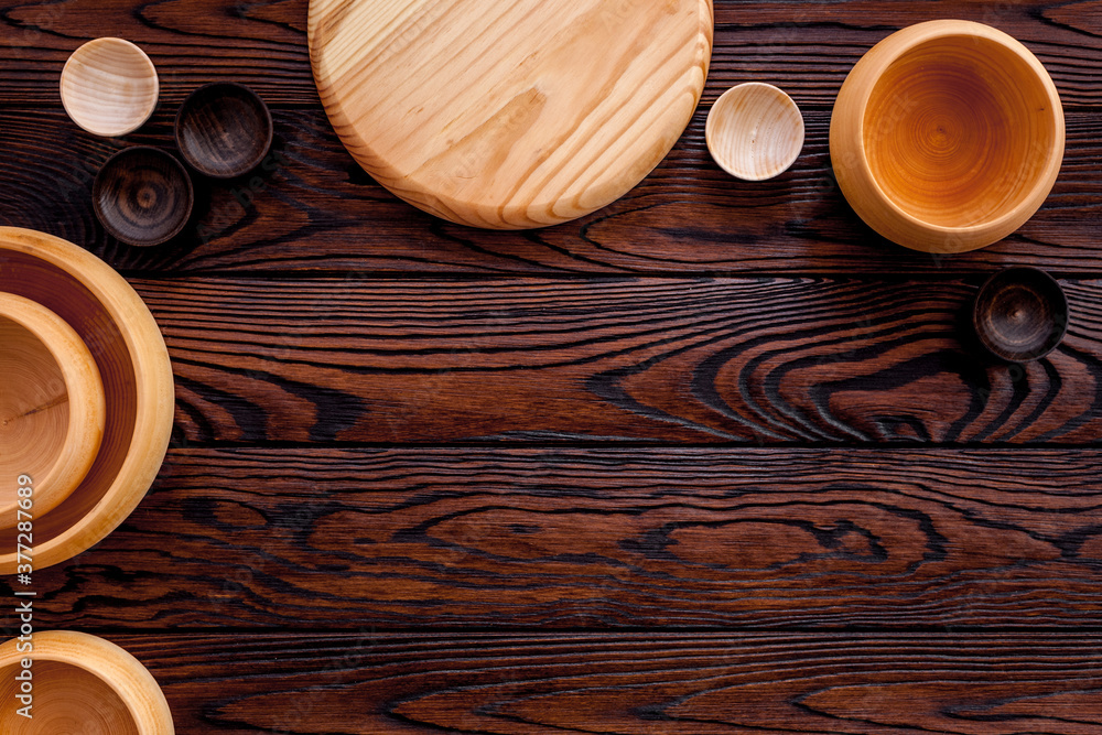 Making wooden dishes. Empty bowls on brown wooden background top view copy space Making wooden dishes. Empty bowls on brown wooden background top view copy space