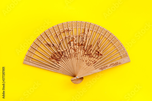 The concept Bamboo fan on Yellow background top view copy space