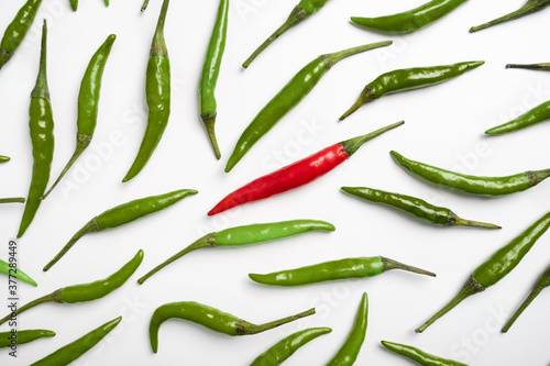 Red and green chilli peppers on a white background.