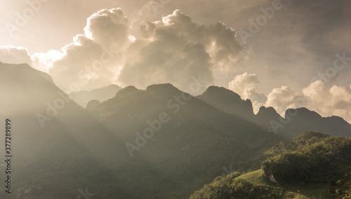 Beautiful golden sunrise vista on mountain at dawn. Miracle of nature in orange golden shading cloud shadow in Chiang Dao, Chiang Mai, Thailand