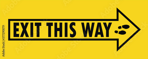 Social distancing concept for preventing coronavirus covid-19 with wording exit this way in black and arrow on yellow black background. warning or caution sign.   