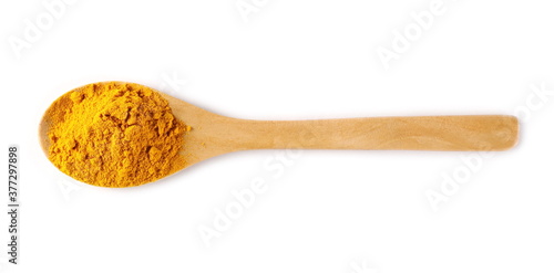 Turmeric (Curcuma) powder pile in wooden spoon isolated on white background, top view