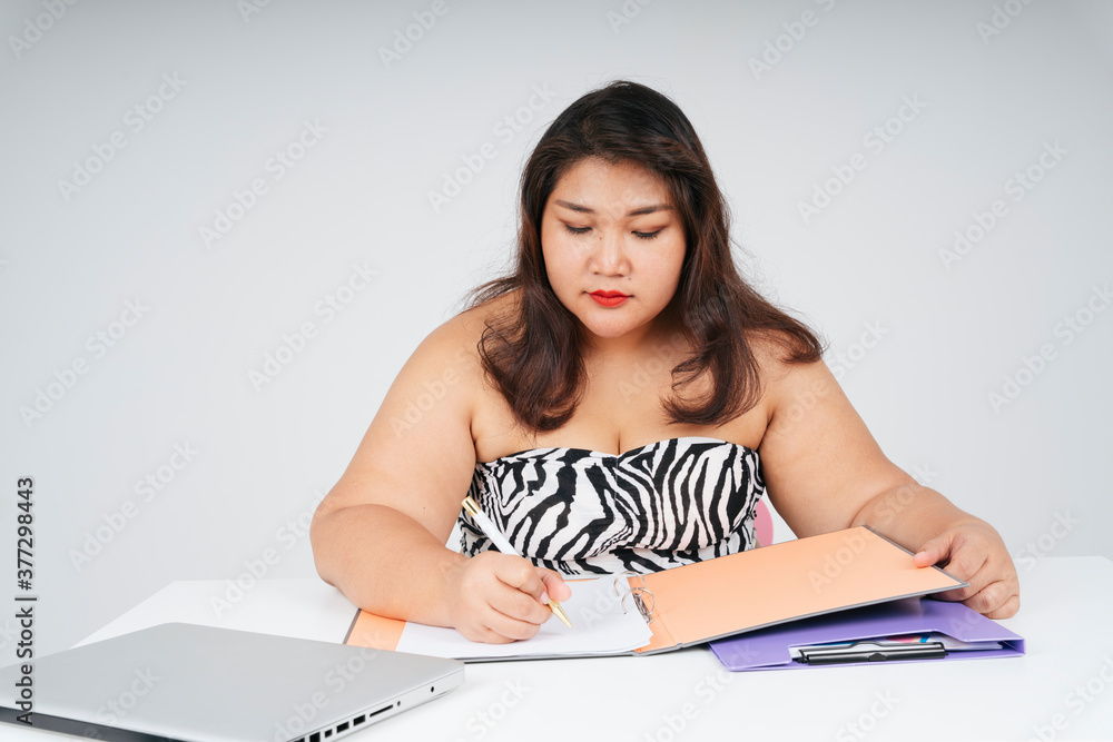 Chubby woman working with papers at desk on white background. Chubby woman working with papers at desk on white background.
