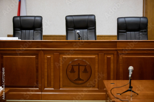 A courtroom in a Russian court, an empty judge's chair