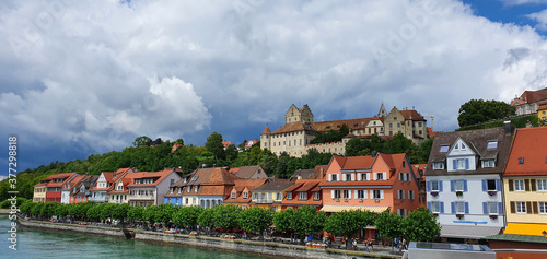 Meersburg Germany July 2020 at the port with a view of the waterfront promenade in fine weather with dramatic clouds