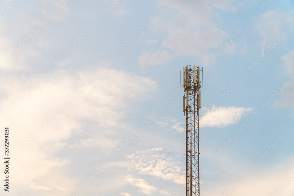 Telecommunication tower with blue sky and cloud in background. Broadcast pole with copy space. Wireless communication technology.