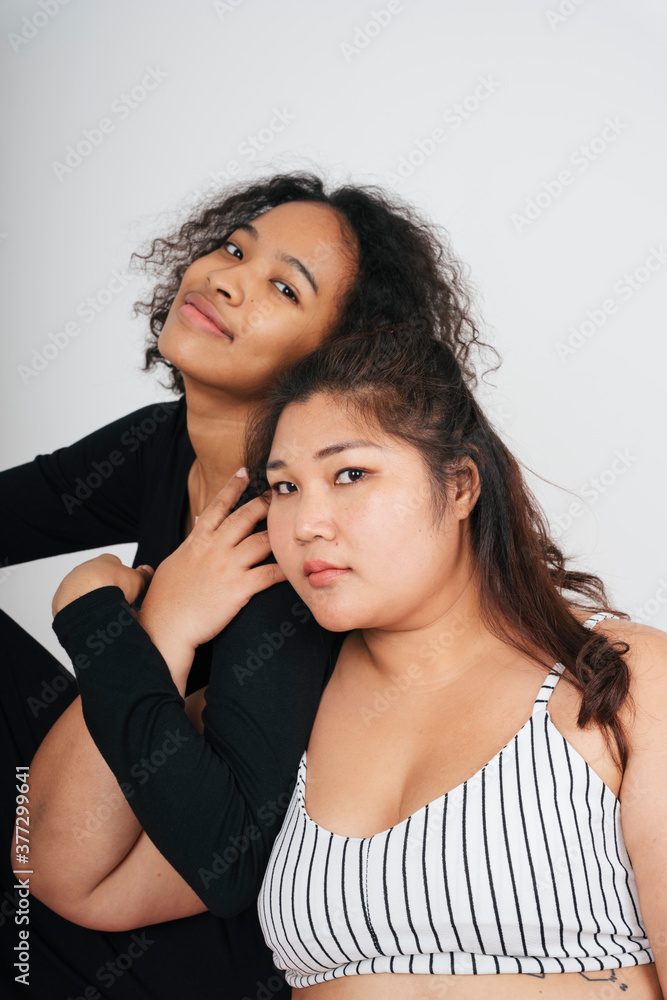 Chubby woman and african curly hairstyle woman over white background. Chubby woman and african curly hairstyle woman over white background.