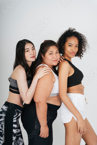 Portrait of diverse with asian and african women in wear sport bra outfit on white background.