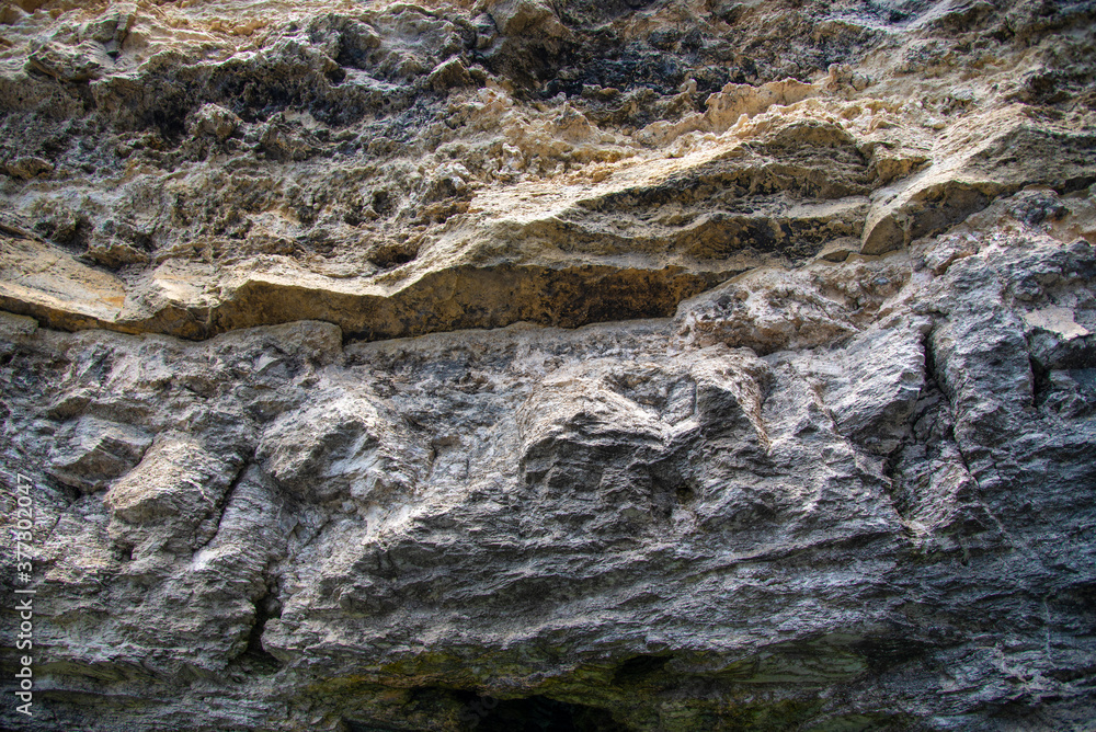 Full frame a fragment of rough uneven rock as a backdrop.