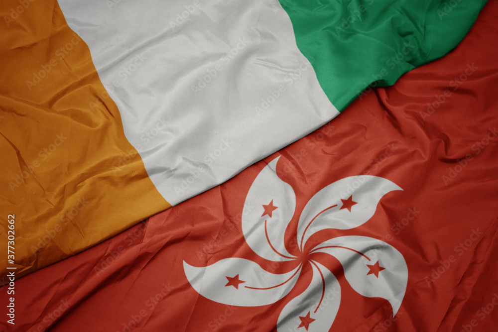 waving colorful flag of hong kong and national flag of cote divoire.