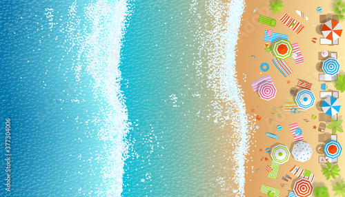 Sunny beach view from above. Summertime - sea, sand, umbrellas, towels, chairs, sunbeds, palm, clothes, objects. (Top view)