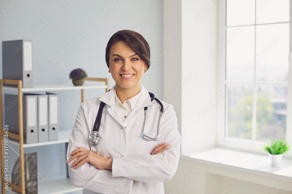 Female doctor looking at camera in hospital. Medical worker communicating with client online, giving consultation on web Female doctor looking at camera in hospital. Medical worker communicating with client online, giving consultation on web