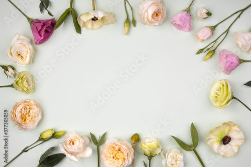 Fototapeta Naklejka Na Ścianę i Meble -  Creative frame made with flowers on pastel background. Spring minimal concept. Flat lay.