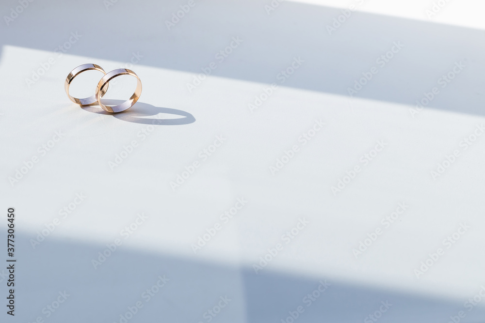 two gold wedding rings on a white background. two gold wedding rings on a white background.