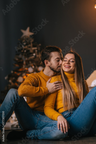 young beautiful couple sitting in a beautiful room on the bed ag