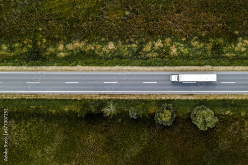 Large freight transporter semi-truck on the road, aerial view