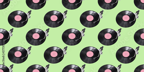 Seamless pattern. Abstract record player part isolated on green background. Disk Jockey turntable and vinyl. Retro music concept.