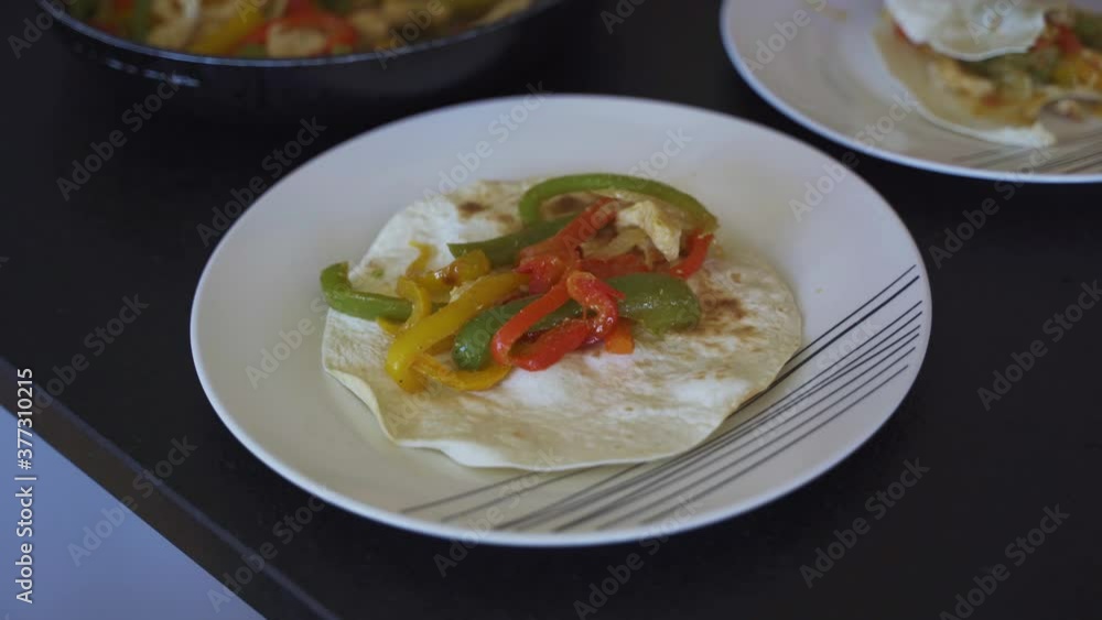 making a Mexican fajita,
eating fajita making a Mexican fajita,
eating fajita