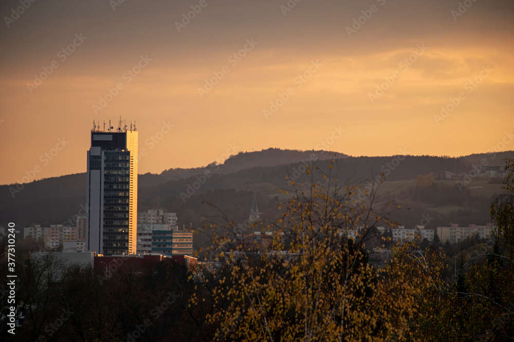 Beautiful autumn sunset with orange sky over Radvan - part of Banska Bystrica, Slovakia. View on office building.