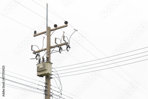 Electric transformer with isolated background. Electric pole with copy space. AC high voltage power transformer.