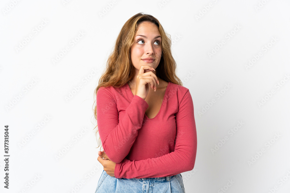 Young blonde woman isolated on blue background thinking an idea while looking up Young blonde woman isolated on blue background thinking an idea while looking up